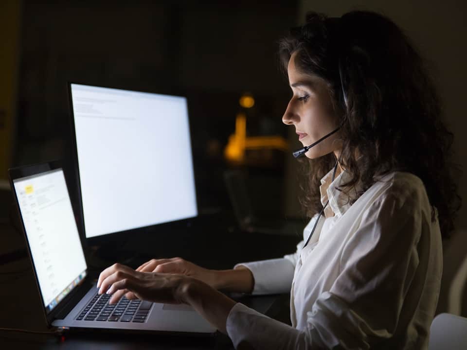 woman wearing a headset working at night